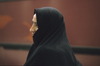 Iran: woman wearing a black chador - photo by W.Allgower