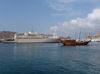 Oman - Muscat: Mutrah - view of the port with a dhow and a large ship - photo by B.Cloutier